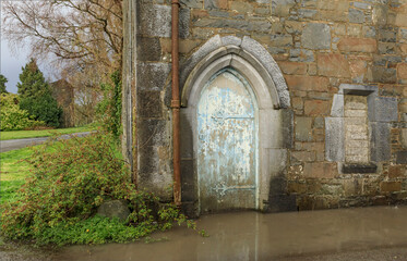 Ancient flooded building with a painted door
