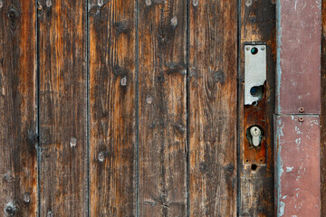 wooden door with a rusty lock