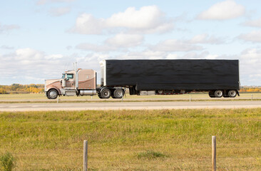 Heavy Cargo on the Road. A truck hauling freight along a highway. Taken in Alberta, Canada