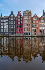 Fototapeta premium Amsterdam downtown - Amstel river, old houses and a bridge. Travel to Europe. Holland, Netherlands, Europe.