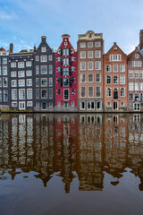 Fototapeta na wymiar Amsterdam downtown - Amstel river, old houses and a bridge. Travel to Europe. Holland, Netherlands, Europe.