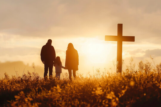 Silhouette of family looking for the cross of Jesus Christ on autumn sunrise background. Easter Sunday concept.