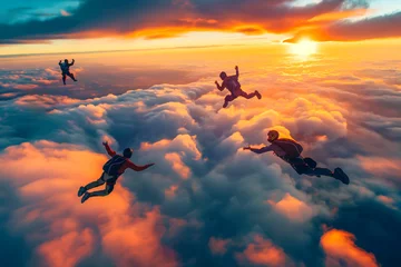 Poster Skydiving group at the sunset Skydivers make a formation above the clouds © MVProductions