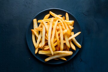 Crispy freshly cooked french fries ready for immediate consumption - obrazy, fototapety, plakaty