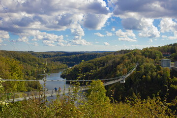 Scenic Overlook of a Suspension Bridge Spanning a Serene River Valley During Autumn. Titan. Germany