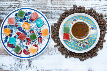 Turkish Coffee Cup and Turkish Delight on the Background of Ottoman Tile Motifs, Colorful Candy and Chocolate, Ramadan Kareem Concept Photo, Üsküdar Istanbul, Turkiye (Turkey)