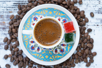 Turkish Coffee Cup and Turkish Delight on the Background of Ottoman Tile Motifs, Colorful Candy and Chocolate, Ramadan Kareem Concept Photo, Üsküdar Istanbul, Turkiye (Turkey)