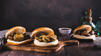Appetizing burgers with grilled mushrooms and herbs on a wooden board web banner