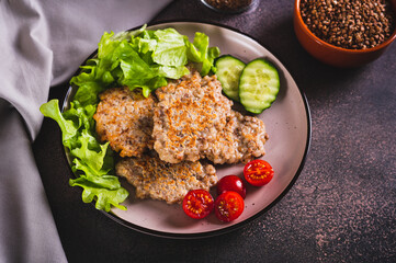 Homemade buckwheat pancakes with fresh vegetables and herbs on a plate on the table
