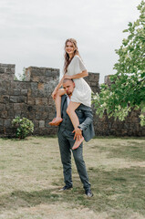 the groom holds the bride on his shoulders