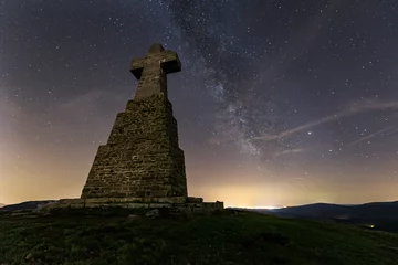 Foto op Plexiglas night view on a summer night with the starry sky and the milky way over the cross of Mount Saibigain in the Urkiola Natural Park, Bizkaia © patxi