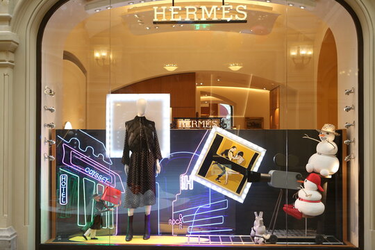 MOSCOW, RUSSIA - JANUARY 9, 2022: Creative show window, store display of Hermes boutique shop in GUM department store in Moscow city (State Department Store). Neon art in show windows. Hermes fashion