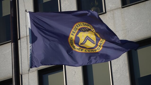 Flags in front of Federal Deposit Insurance Corporation building in Washington, DC.