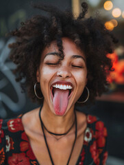 happy black woman sticking tongue out - obrazy, fototapety, plakaty