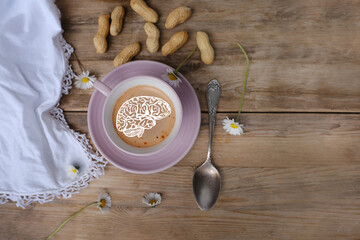 cup with drink coffee cappuccino and foam in brain form on old vintage wooden table, caffeine...