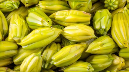 a pile of unripe bananas sitting next to each other on top of a pile of unripe bananas.