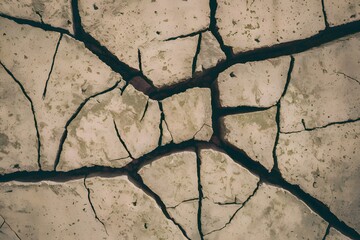 Abstract background showcases cracks in textured cement wall