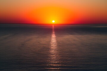 Image Aerial view captures serene sunset over calm sea