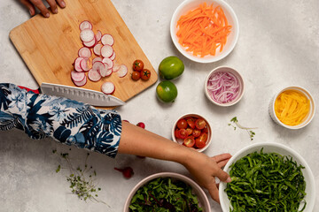 Cooking Healthy Ingredients for Salad with Woman Cutting Radish