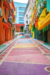 Bright colored backstreet with walls painted in graffiti style. Modern urban environment