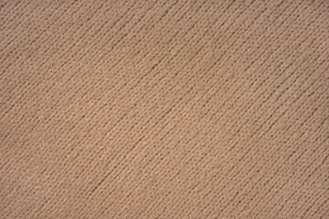 Brown knitted woolen jersey fabric with diagonal weaving, sweater, pullover texture background....