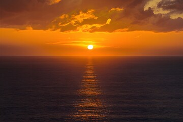 Obraz premium Publish Aerial view of golden sunset sky over the sea