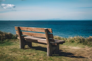 Naklejka na ściany i meble shot Wooden bench with sea view, perfect for relaxation and contemplation