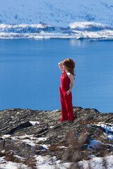 a woman in red in the snow.