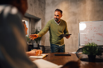 Businessman presenting and pitching business ideas at boardroom.