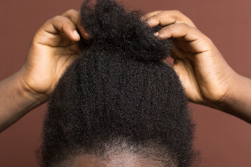 Detangling black afro curly hair with shrinkage, Type 4c hair being detangled and stretched out