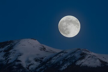 StockImage Shiny full moon glows brightly in clear night sky