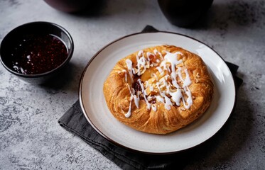 Puffed cake with raspberry jam, vanilla custard cream and almonds