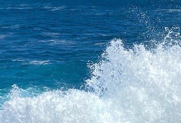 Fototapeta premium Blue ocean water with splashing waves natural texture background.Selective focus.