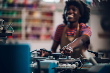 Fototapeta na wymiar Close up of interracial printing shop worker adjusting printing press.