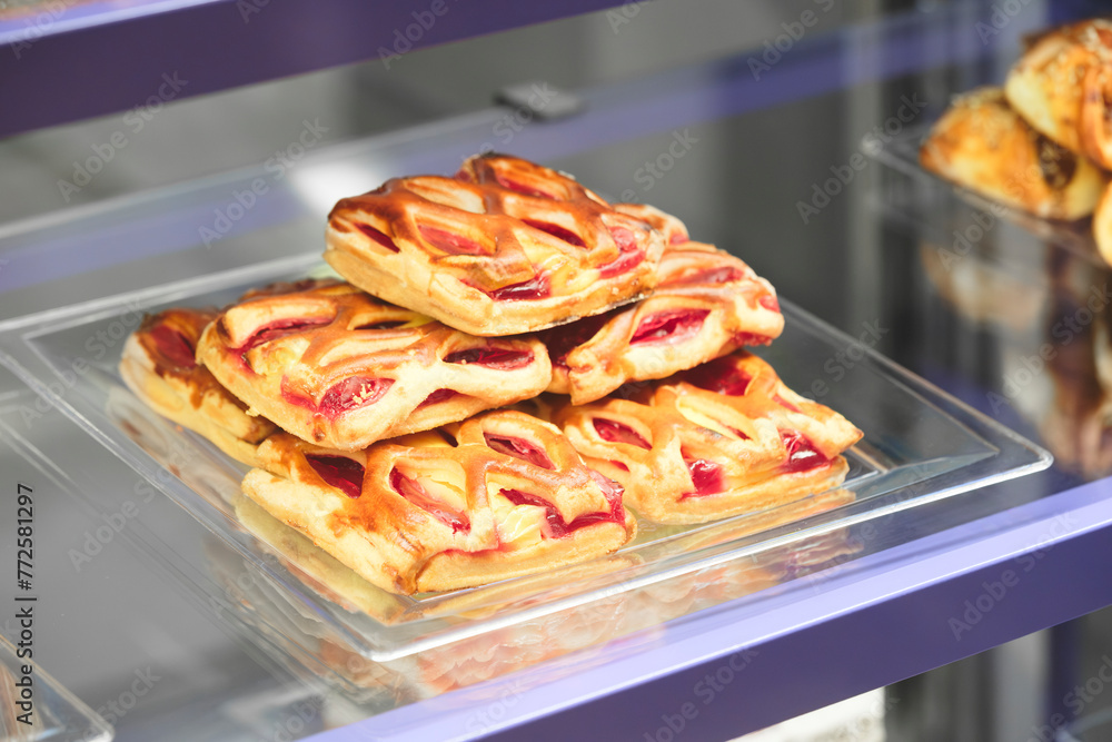 Poster a stack of pastries with a pink filling. the pastries are arranged in a pyramid shape
