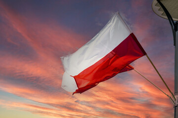 National state flag of Poland and stormy sunset sky