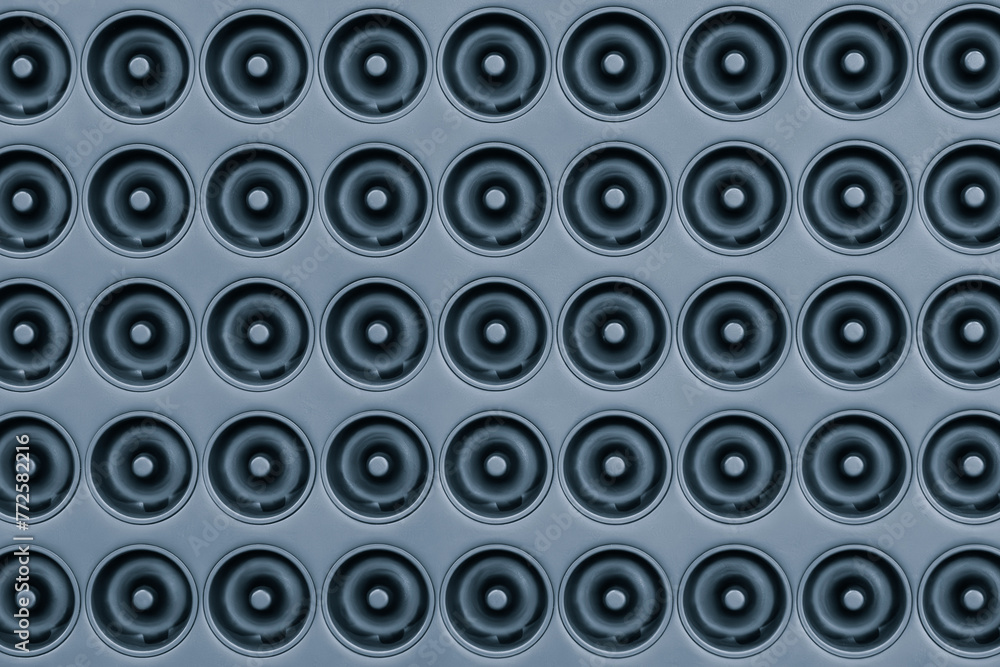 Poster A blue background of many circles of various sizes. The circles are all different sizes and are arranged in a pattern. The photo has a somewhat abstract and minimalist feel to it