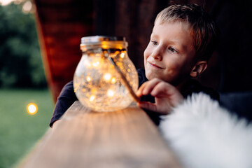 Portrait of a Radiant Kid Looking At a Jar With Lights, Childish Moments
