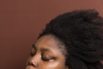 A woman with stretched out curly hair to emphasize shrinkage, 4c hair stretched to show shrinkage