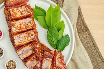 Marinated raw ribs with spices and herbs. Traditional ingredient for BBQ, picnic concept