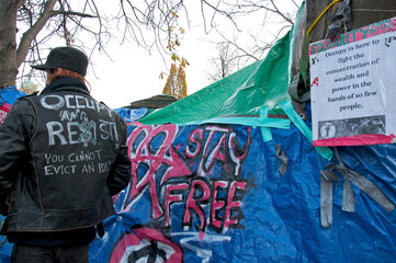 Homeless people resist the eviction to remove the tent city in the public park