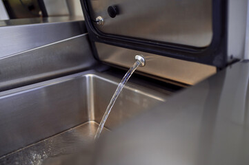 Industrial dishwasher in restaurant kitchen washing dishes