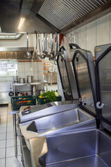Industrial dishwasher in restaurant kitchen washing dishes