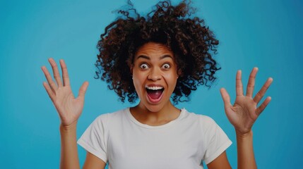 A woman with curly hair is smiling and waving her hands in the air. Concept of joy and excitement