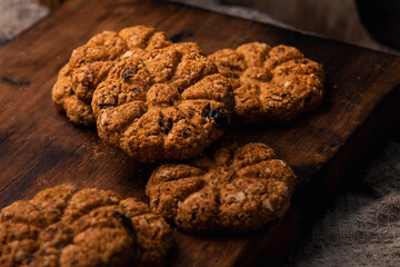 oatmeal and raisin cookies on wooden table with milk