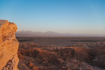 Fototapeta na wymiar Landscape of rocky hills and mountains in San Pedro de Atacama desert, Chile. Sunset.