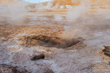 A rocky hole in the ground in Tatio geysers in the Atacama desert, Chile