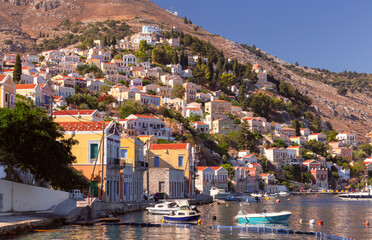 Multi-colored facades of houses in the Greek village Symi on a sunny day - 772603098