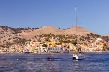 Multi-colored facades of houses in the Greek village Symi on a sunny day - 772603282