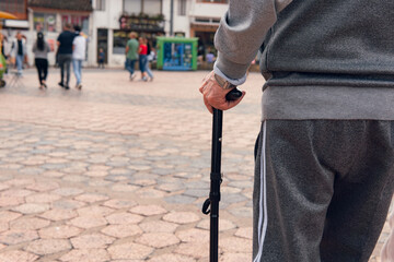 older man walking with cane and comfortable clothes